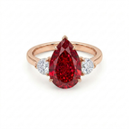 Royal Crimson Pear Ruby Ring with Diamond Side Stones in Solid Gold